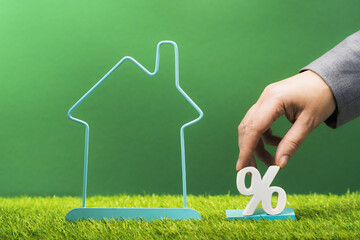 Property investment and house mortgage financial real estate concept. Percentage sign within house...