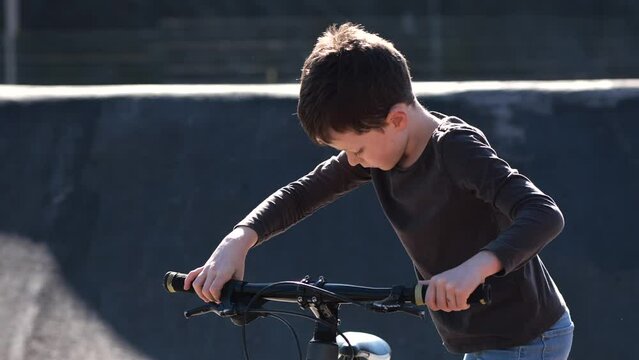 Caucasian elementary boy riding a bicycle