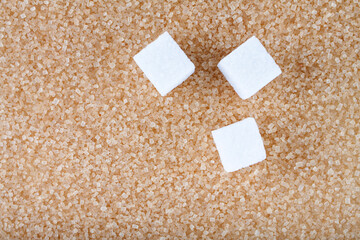 Brown sugar macro background from crystals and white sugar cubes