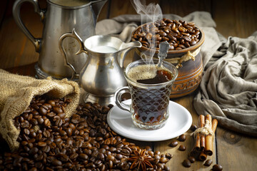 Espresso coffee with coffee beans on old background.