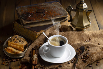 Espresso coffee with coffee beans on old background.