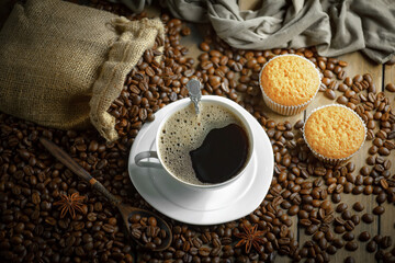 Espresso coffee with coffee beans on old background.
