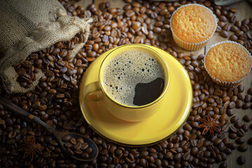 Espresso coffee with coffee beans on old background.