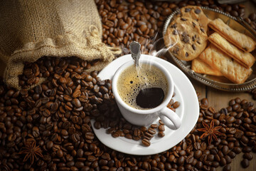 Espresso coffee with coffee beans on old background.