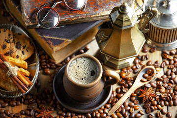 Espresso coffee with coffee beans on old background.