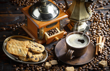 Espresso coffee with coffee beans on old background.