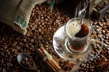 Espresso coffee with coffee beans on old background.