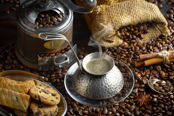 Espresso coffee with coffee beans on old background.