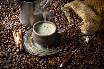 Espresso coffee with coffee beans on old background.
