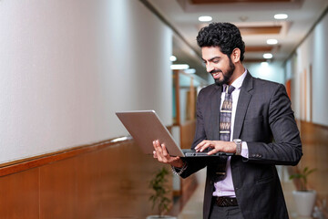 Indian businessman using laptop at office