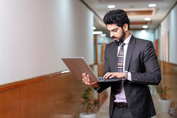 Indian businessman using laptop at office