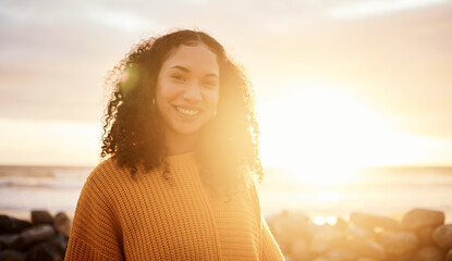 Travel, sunset and portrait of a woman at the beach while on a zen vacation or weekend trip. Happy, smile and calm female from Puerto Rico by the ocean while on a seaside holiday or adventure.