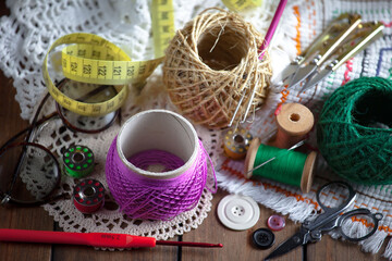 Colored threads and items for sewing, on an old background.