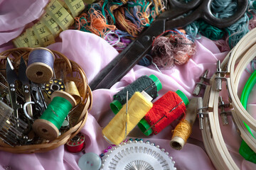 Colored threads and items for sewing, on an old background.