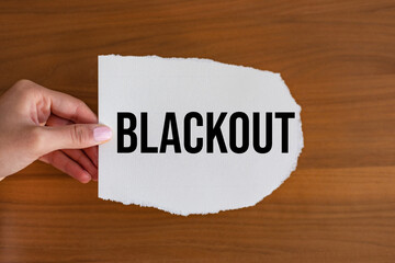 Blackout. Woman hand holds a piece of paper with a note, blackout. Power cut, electricity,...