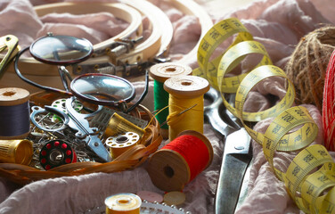 Colored threads and items for sewing, on an old background.