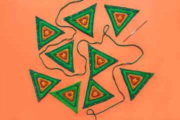 Top view on green crochet motifs of triangle form,  green croche