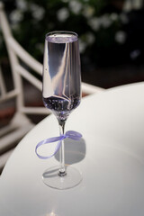 A glass of fresh cocktail with lavender on a white table