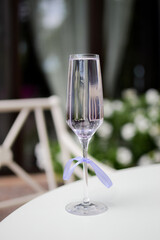 Glasses of with white champagne with lavender on blurred background.