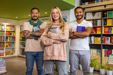 Students standing with books in library