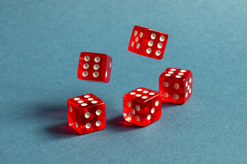 Random number generator. Five red dice with numerical values lie in a chaotic order.