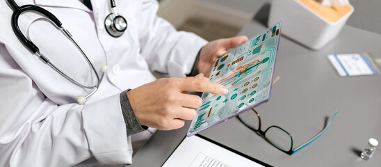 Unrecognizable female doctor touching with finger transparent tablet with medical digital diagnostic on screen. Futuristic health care head up display concept.