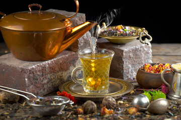 Hot sweet tea in a cup on old background