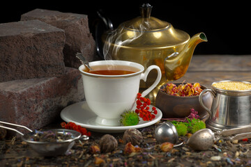Hot sweet tea in a cup on old background
