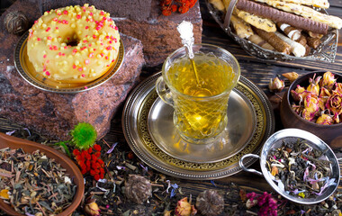 Hot sweet tea in a cup on old background
