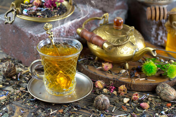 Hot sweet tea in a cup on old background