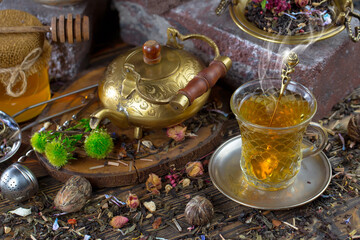 Dry tea leaves in a spoon on an old background