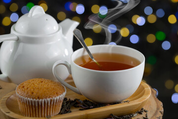 Hot sweet tea in a cup on old background