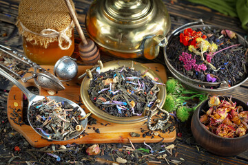 Dried tea leaves in a spoon, on an old background.