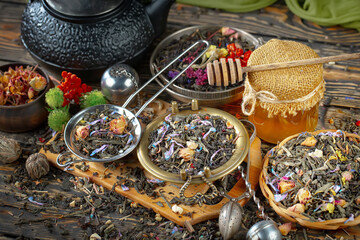 Dried tea leaves in a spoon, on an old background.