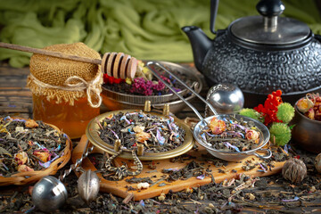 Dry tea leaves in a spoon on an old background