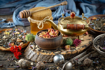 Dried tea leaves in a spoon, on an old background.