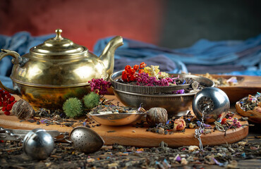 Dried tea leaves in a spoon, on an old background.