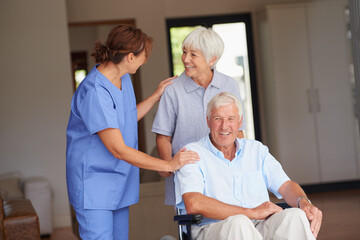 Hell be on his feet in no time. a nurse giving good news to her senior patient and his wife.