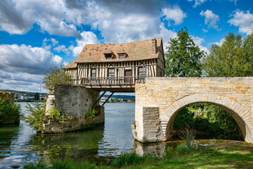 the old mill bridge at vernon in france over the river seine