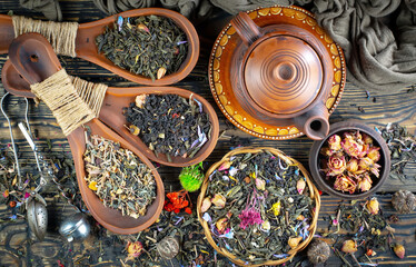 Dried tea leaves in a spoon, on an old background.