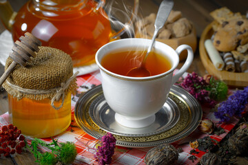 Sweet, hot tea with dessert, on an old background.