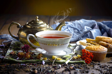 Sweet, hot tea with dessert, on an old background.