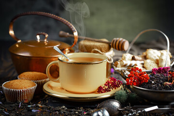 Sweet, hot tea with dry tea leaves, on an old background.