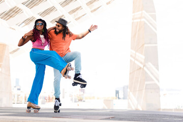 Cheerful couple roller skating outside. Fun sexy boyfriend and girlfriend enjoy in sunny day