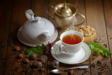 Sweet, hot tea with dessert, on an old background.