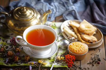 Sweet, hot tea with dessert, on an old background.