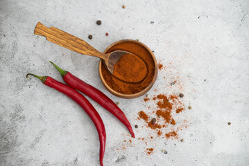 Curry, chili peppers, garlic on a gray background.