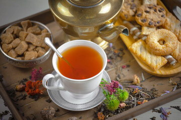 Sweet, hot tea with dessert, on an old background.