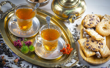 Sweet, hot tea with dessert, on an old background.