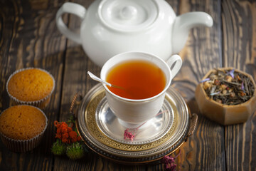 Sweet, hot tea with dessert, on an old background.